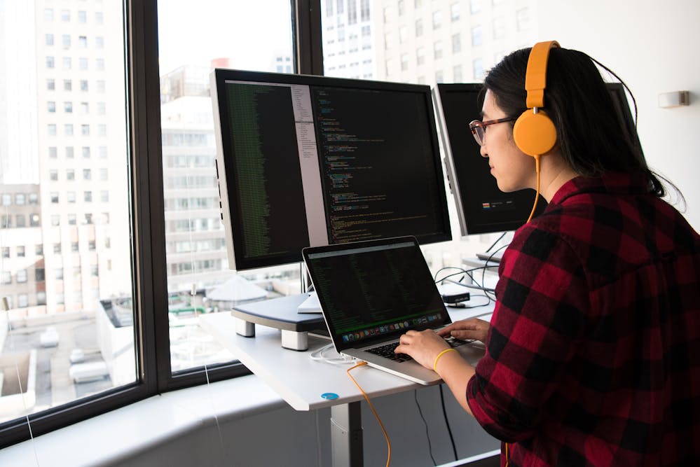 Woman coding on laptop